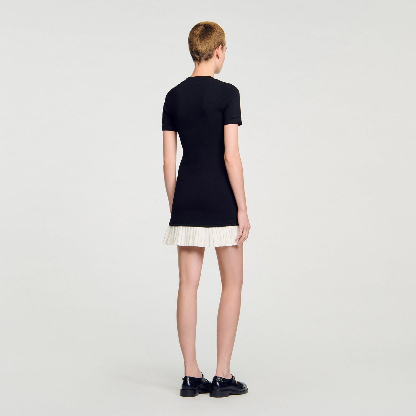 Sandro Mini knit dress with ruffle Black / Ecru